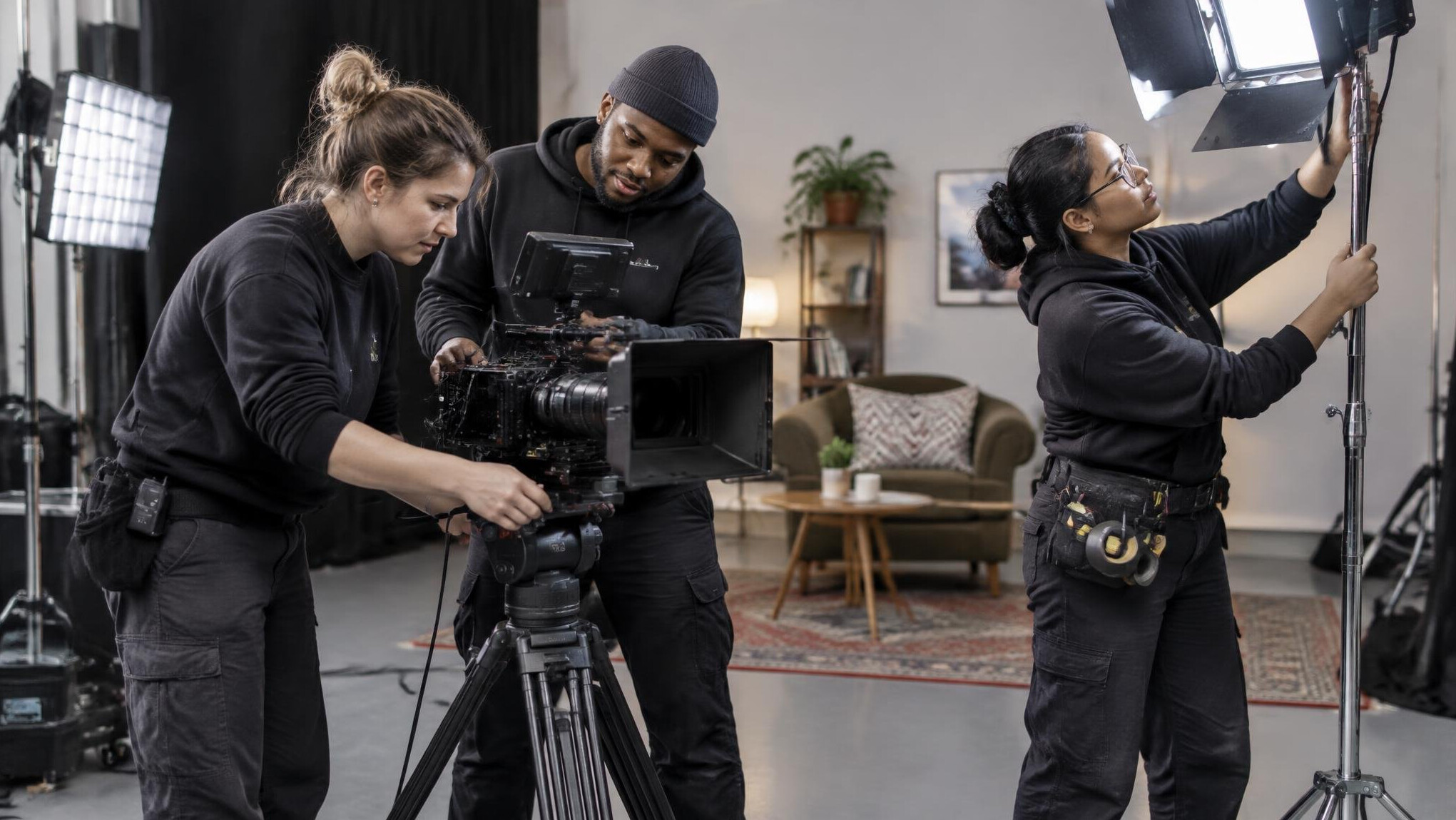 Camera crew setting up equipment on a production set